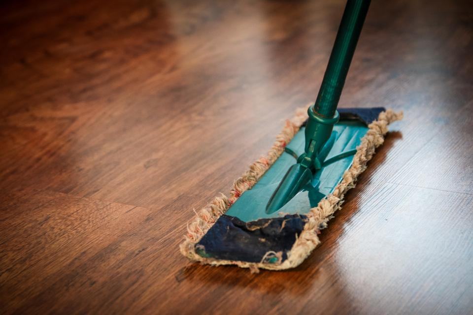 A mop on a clean wooden floor